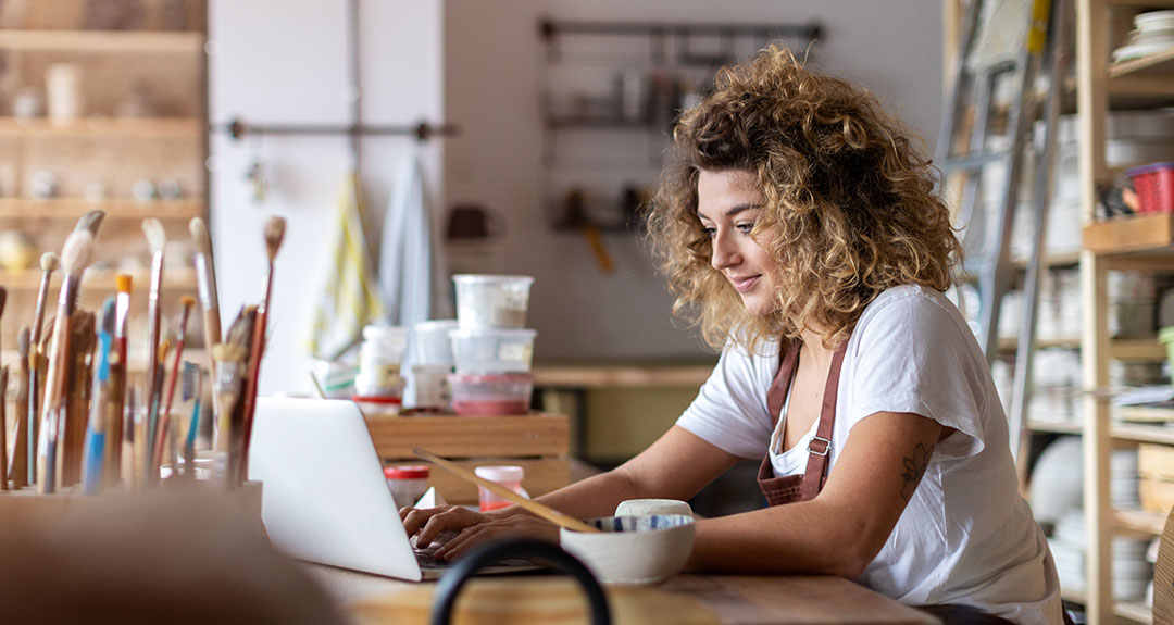 an artist viewing her laptop